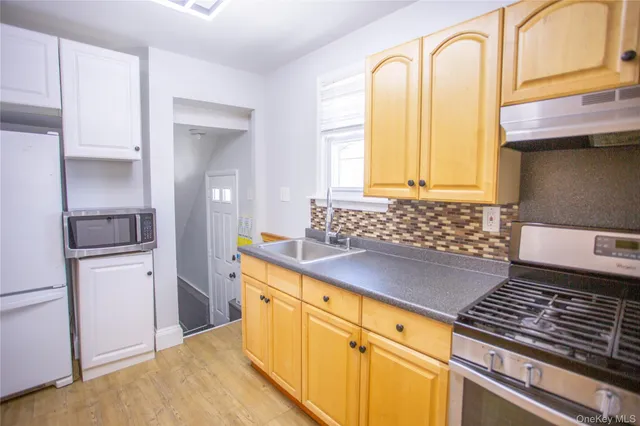 a kitchen with stainless steel appliances granite countertop a stove and a refrigerator