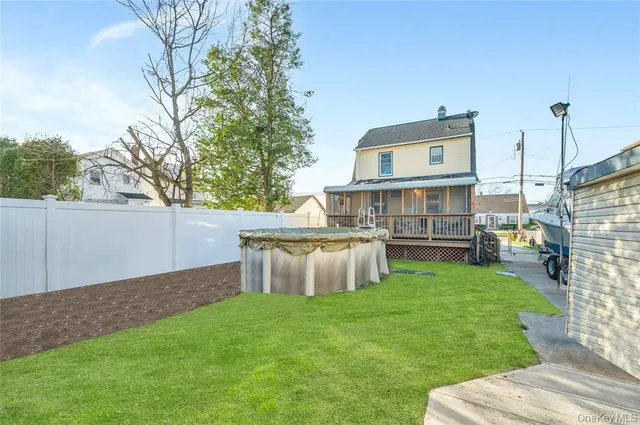 a view of a backyard with a garden and entertaining space