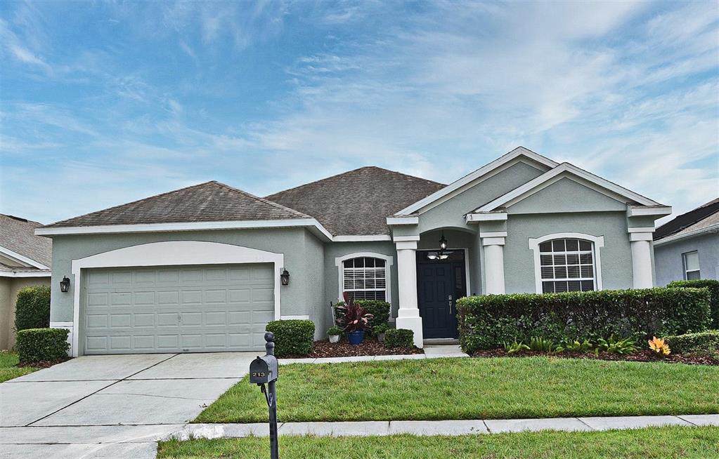 213 Tavestock Loop Winter Springs, FL 32708 - Photo 1 of 1 a front view of a house with a yard