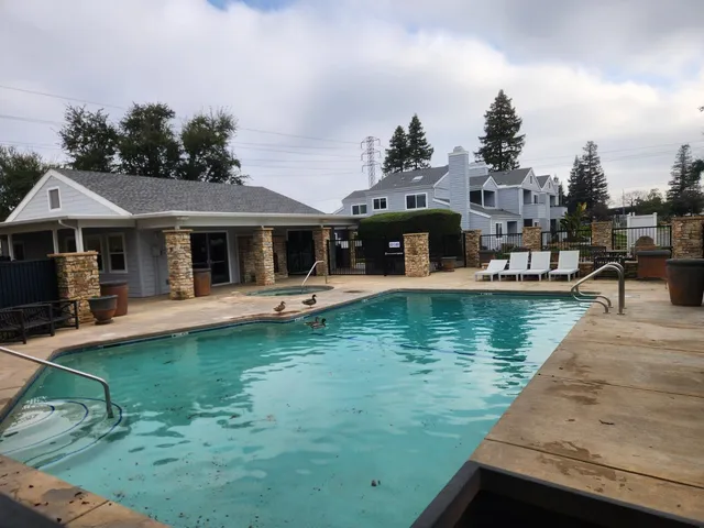 a front view of a house with swimming pool having outdoor seating