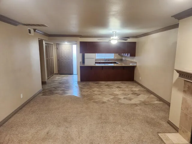 a view of empty room with a fireplace