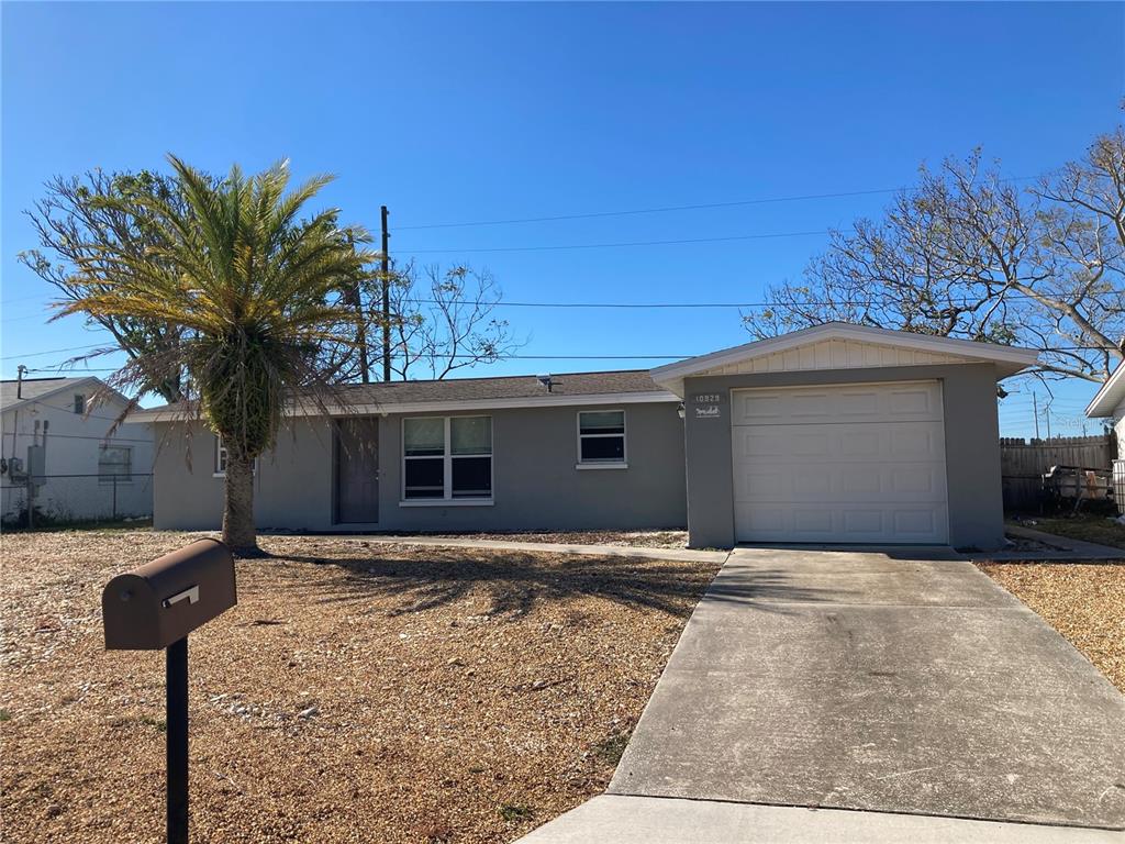 10929 Premier Avenue Port Richey, FL 34668 - Photo 1 of 1 a front view of a house with garden