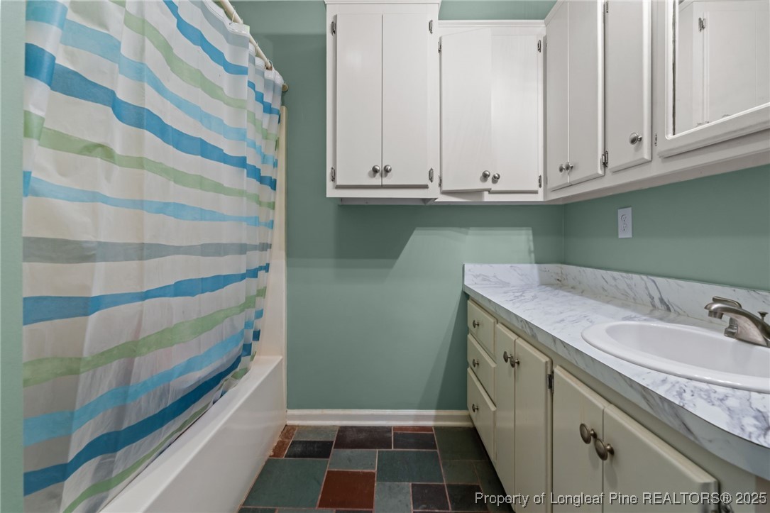 1430 Cypress Church Road Cameron, NC 28326 - Photo 19 of 42 a bathroom with a granite countertop sink and a washing machine
