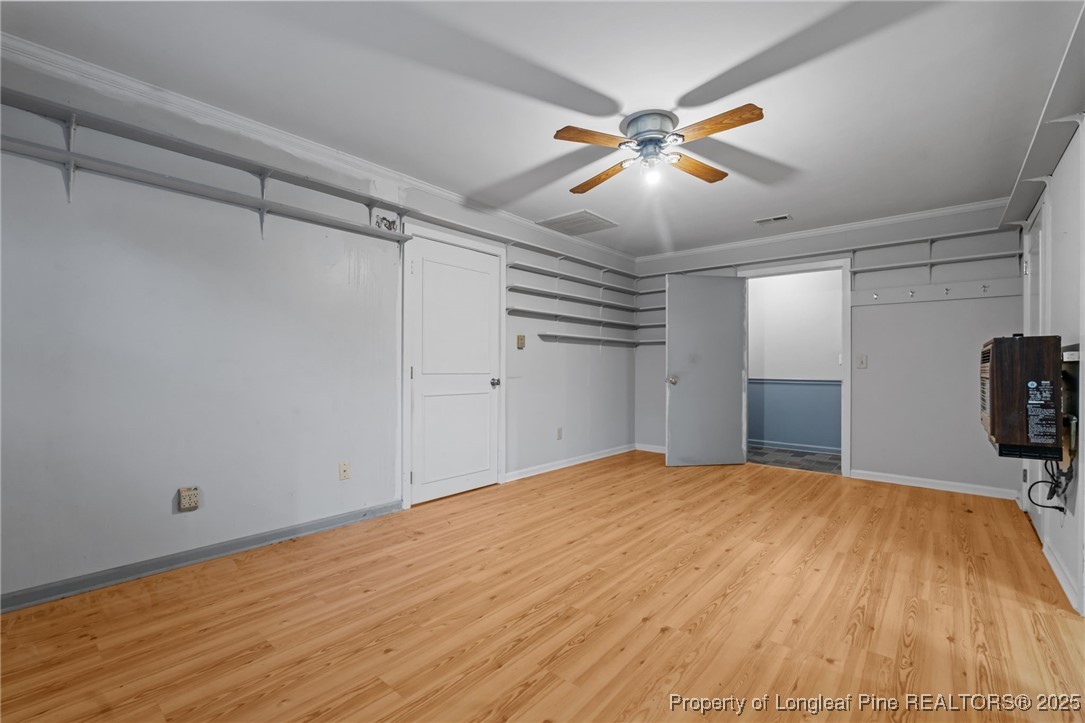 1430 Cypress Church Road Cameron, NC 28326 - Photo 24 of 42 a view of a livingroom with a ceiling fan and wooden floor
