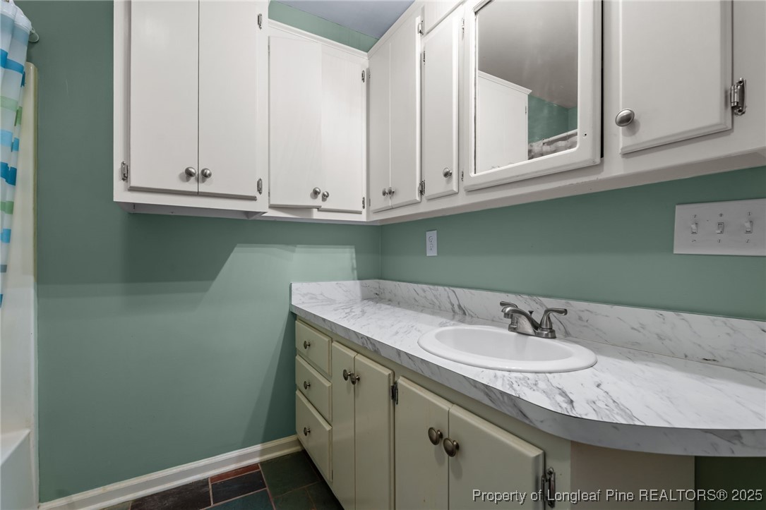 1430 Cypress Church Road Cameron, NC 28326 - Photo 25 of 42 a bathroom with a sink and cabinets