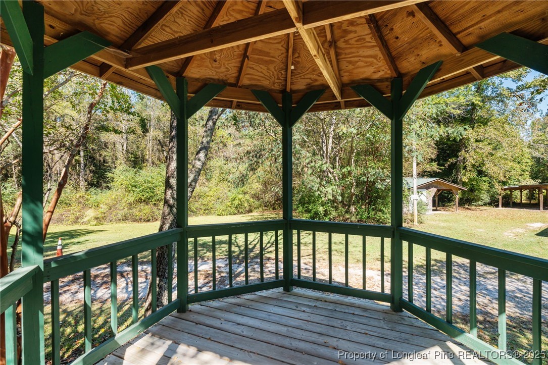 1430 Cypress Church Road Cameron, NC 28326 - Photo 7 of 42 a view of a porch with wooden floor