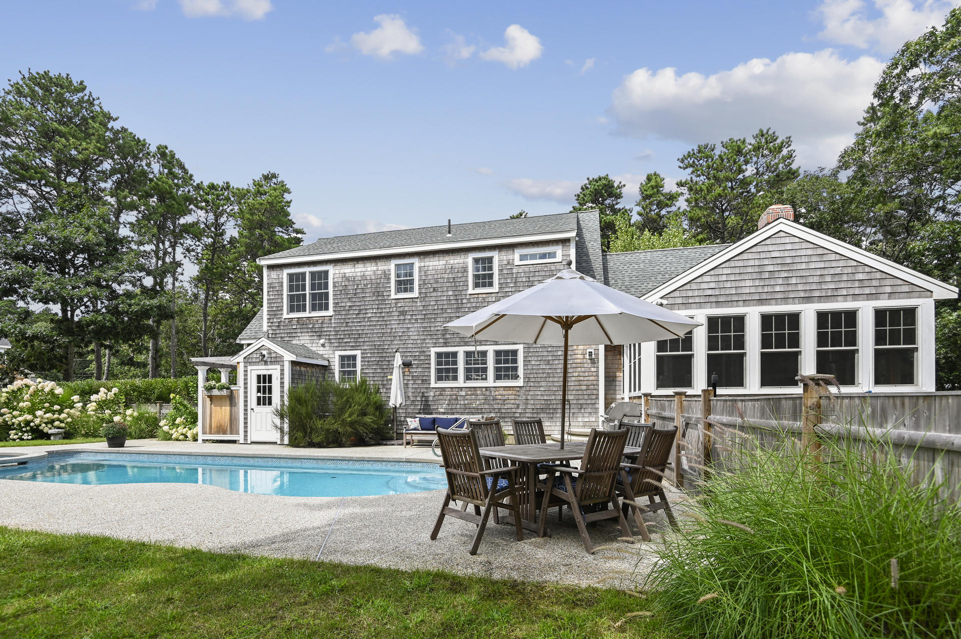 20 Hughes Road Eastham, MA 02642 - Photo 19 of 20 a front view of a house with a yard table and chairs