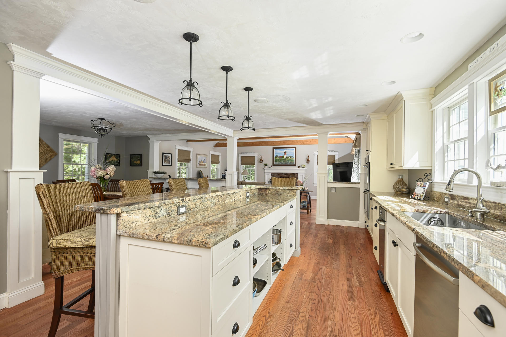 20 Hughes Road Eastham, MA 02642 - Photo 7 of 20 a large kitchen with kitchen island a large counter space a sink appliances and living room view