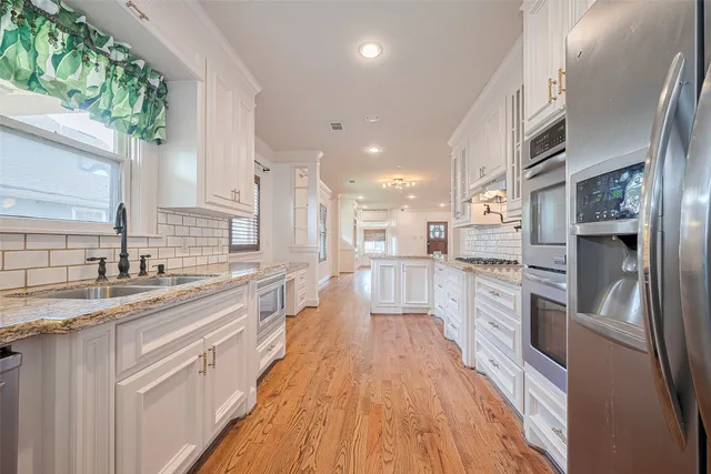 a kitchen with granite countertop a sink and cabinets