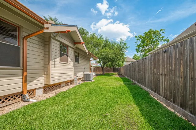 a view of a yard with a house and a tree