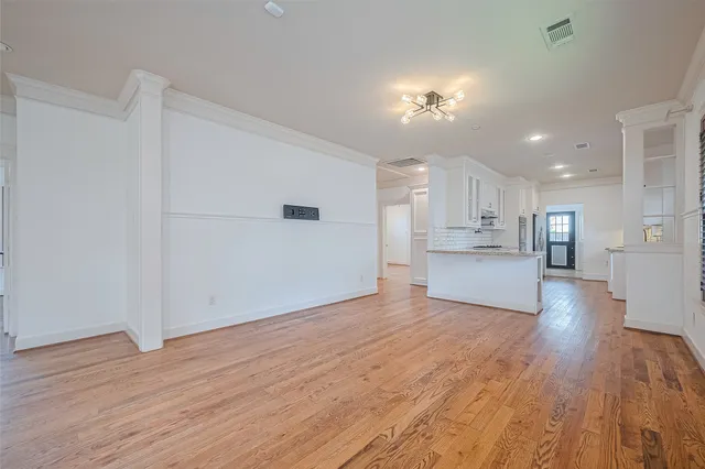 a view of a room with wooden floor and windows
