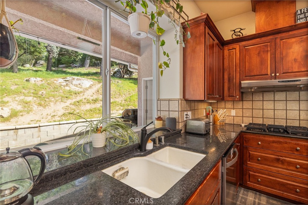 36919 Deer Path Circle Coarsegold, CA 93614 - Photo 18 of 59 a bathroom with a granite countertop sink and a large mirror