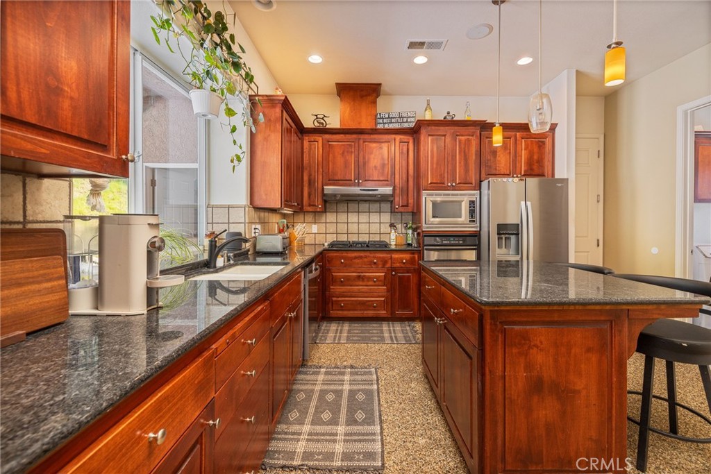 36919 Deer Path Circle Coarsegold, CA 93614 - Photo 19 of 59 a kitchen with stainless steel appliances granite countertop a refrigerator a oven a sink and dishwasher