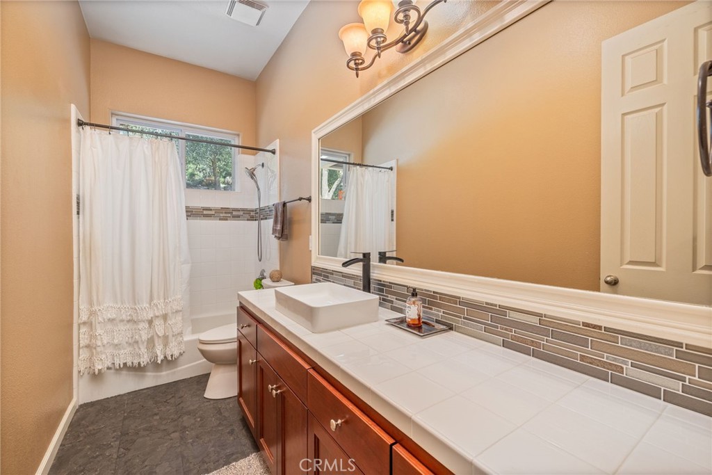 36919 Deer Path Circle Coarsegold, CA 93614 - Photo 22 of 59 a bathroom with a sink a toilet and a mirror