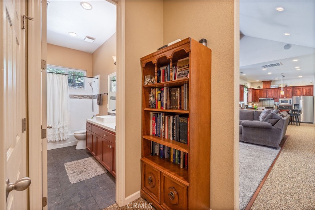 36919 Deer Path Circle Coarsegold, CA 93614 - Photo 23 of 59 a living room with furniture and a book shelf
