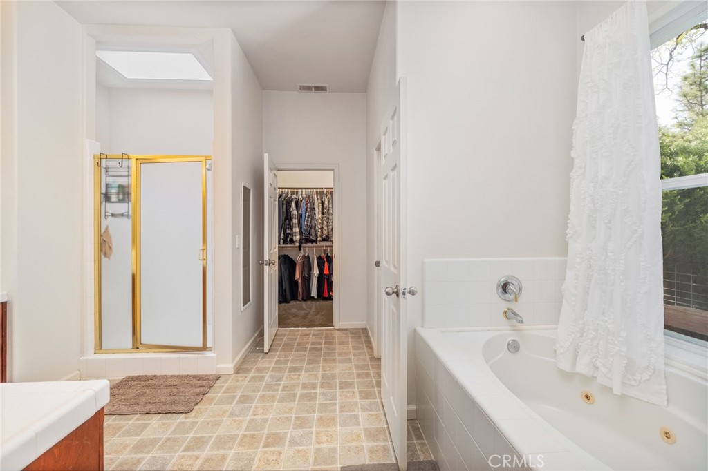36919 Deer Path Circle Coarsegold, CA 93614 - Photo 30 of 59 a bathroom with a bathtub and a shower