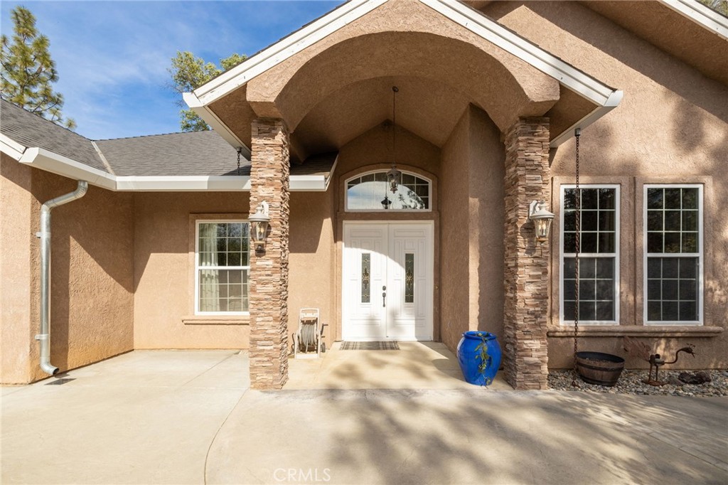 36919 Deer Path Circle Coarsegold, CA 93614 - Photo 3 of 59 a view of a house with large windows