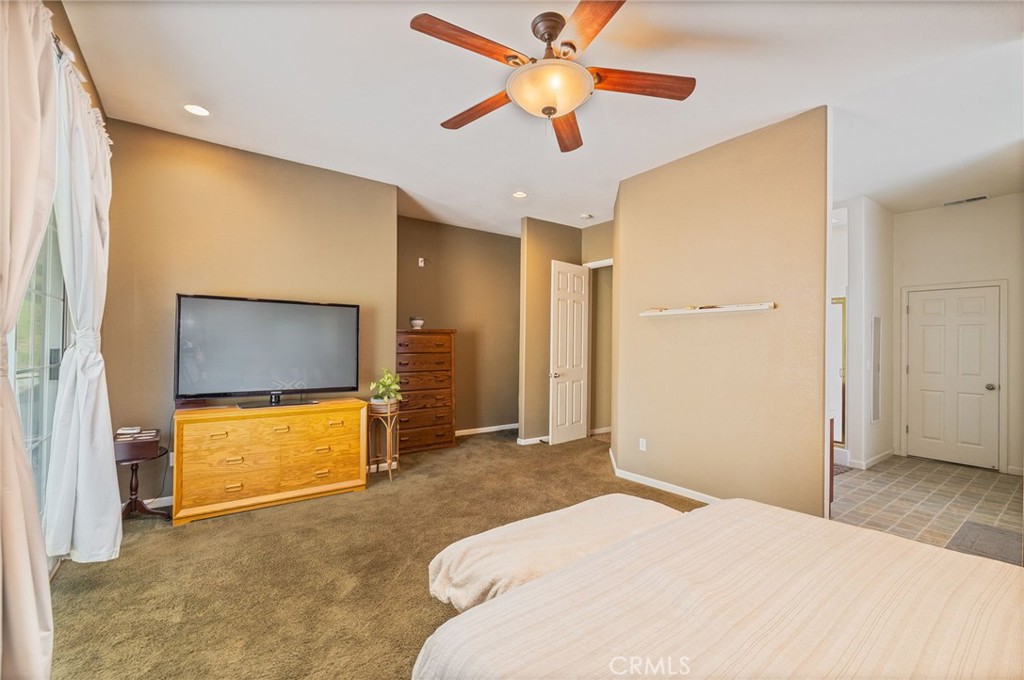 36919 Deer Path Circle Coarsegold, CA 93614 - Photo 34 of 59 a bedroom with a bed and a flat screen tv