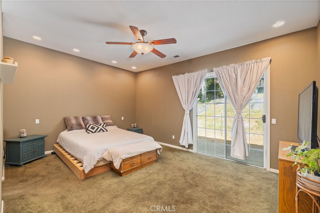 36919 Deer Path Circle Coarsegold, CA 93614 - Photo 35 of 59 a bedroom with a bed and a chandelier
