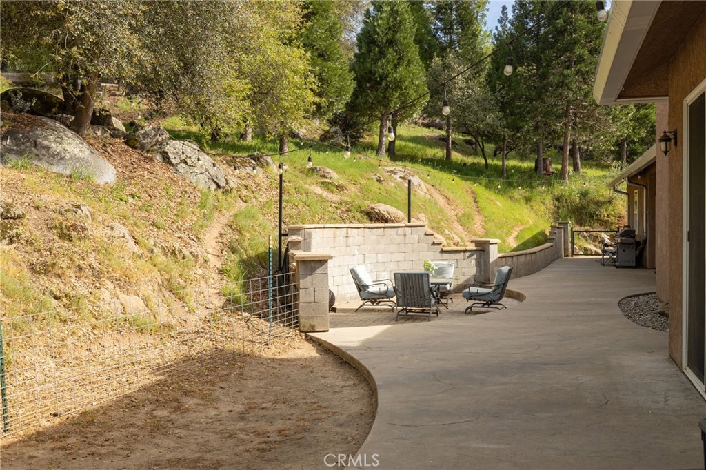 36919 Deer Path Circle Coarsegold, CA 93614 - Photo 40 of 59 a view of a lake with a bench and trees