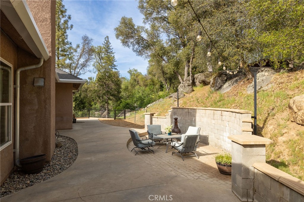 36919 Deer Path Circle Coarsegold, CA 93614 - Photo 41 of 59 a view of a patio with table and chairs and potted plants
