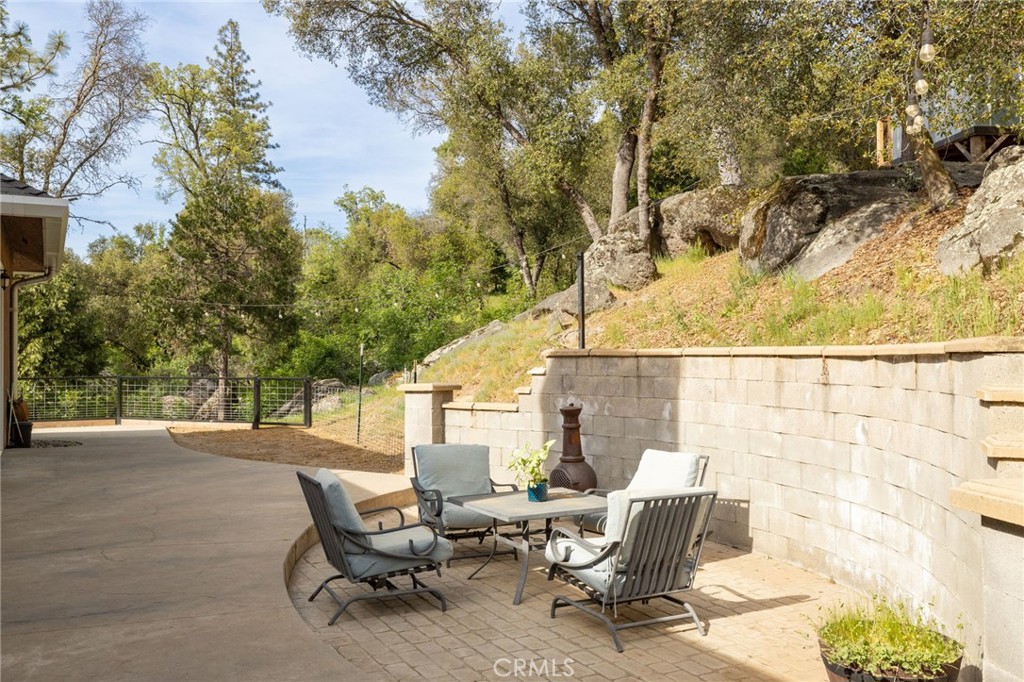 36919 Deer Path Circle Coarsegold, CA 93614 - Photo 42 of 59 a backyard of a house with table and chairs