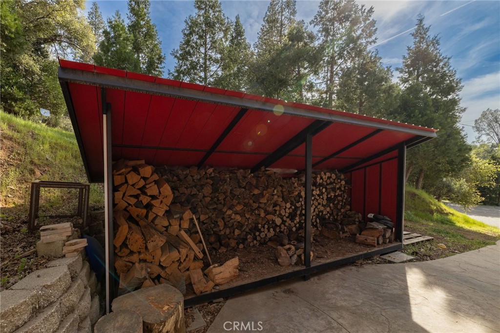 36919 Deer Path Circle Coarsegold, CA 93614 - Photo 47 of 59 a view of a small barn with wooden wall and roof