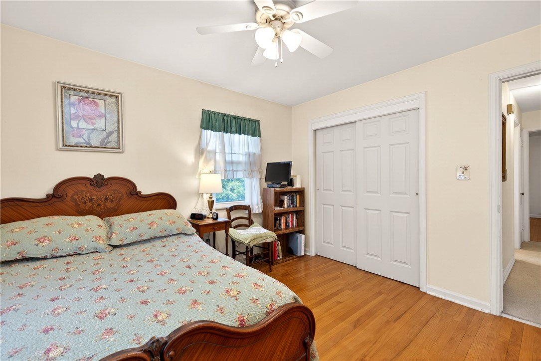 1237 Laurelwood Road Dayton, OH 45409 - Photo 19 of 56 This inviting bedroom features rich hardwood flooring and a functional ceiling fan.