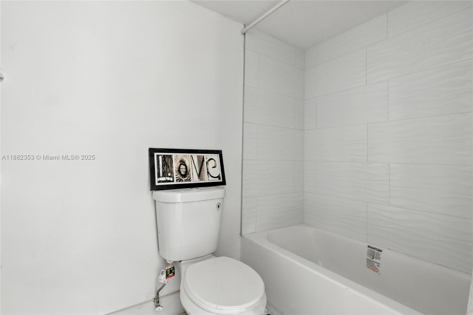 4165 Southwest 66th Terrace, Unit 109 Davie, FL 33314 - Photo 16 of 31 a white toilet sitting next to a bath tub