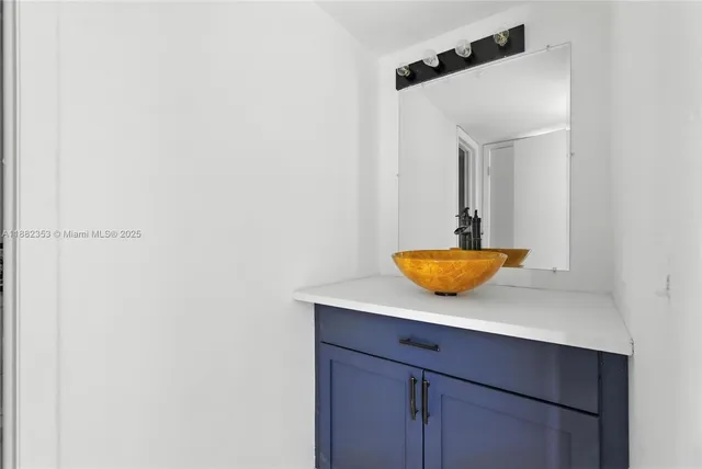 a view of bathroom with a sink and mirror