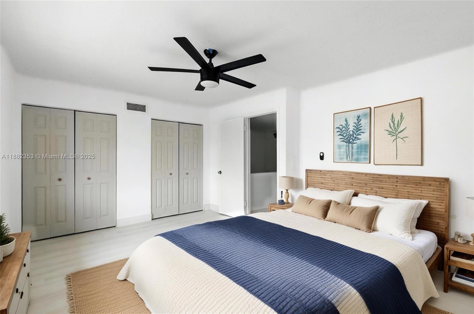 4165 Southwest 66th Terrace, Unit 109 Davie, FL 33314 - Photo 21 of 31 a bedroom with a large bed and a chandelier