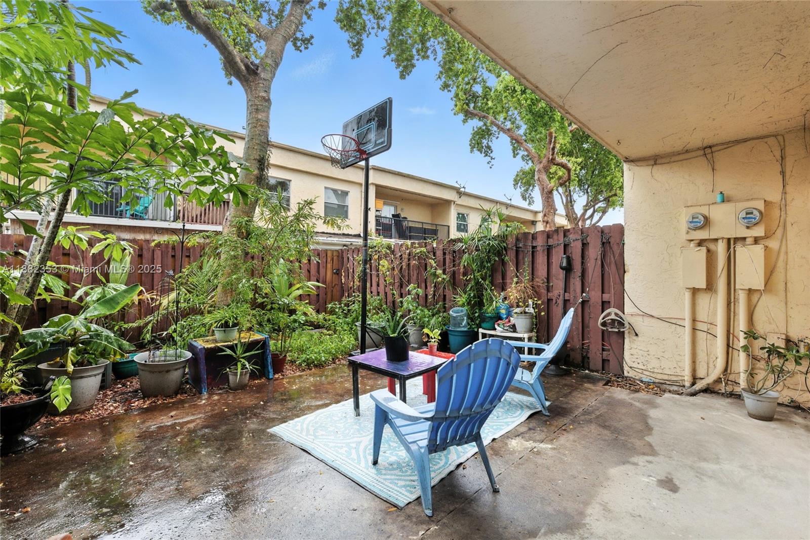 4165 Southwest 66th Terrace, Unit 109 Davie, FL 33314 - Photo 28 of 31 a view of a chair and table in the backyard