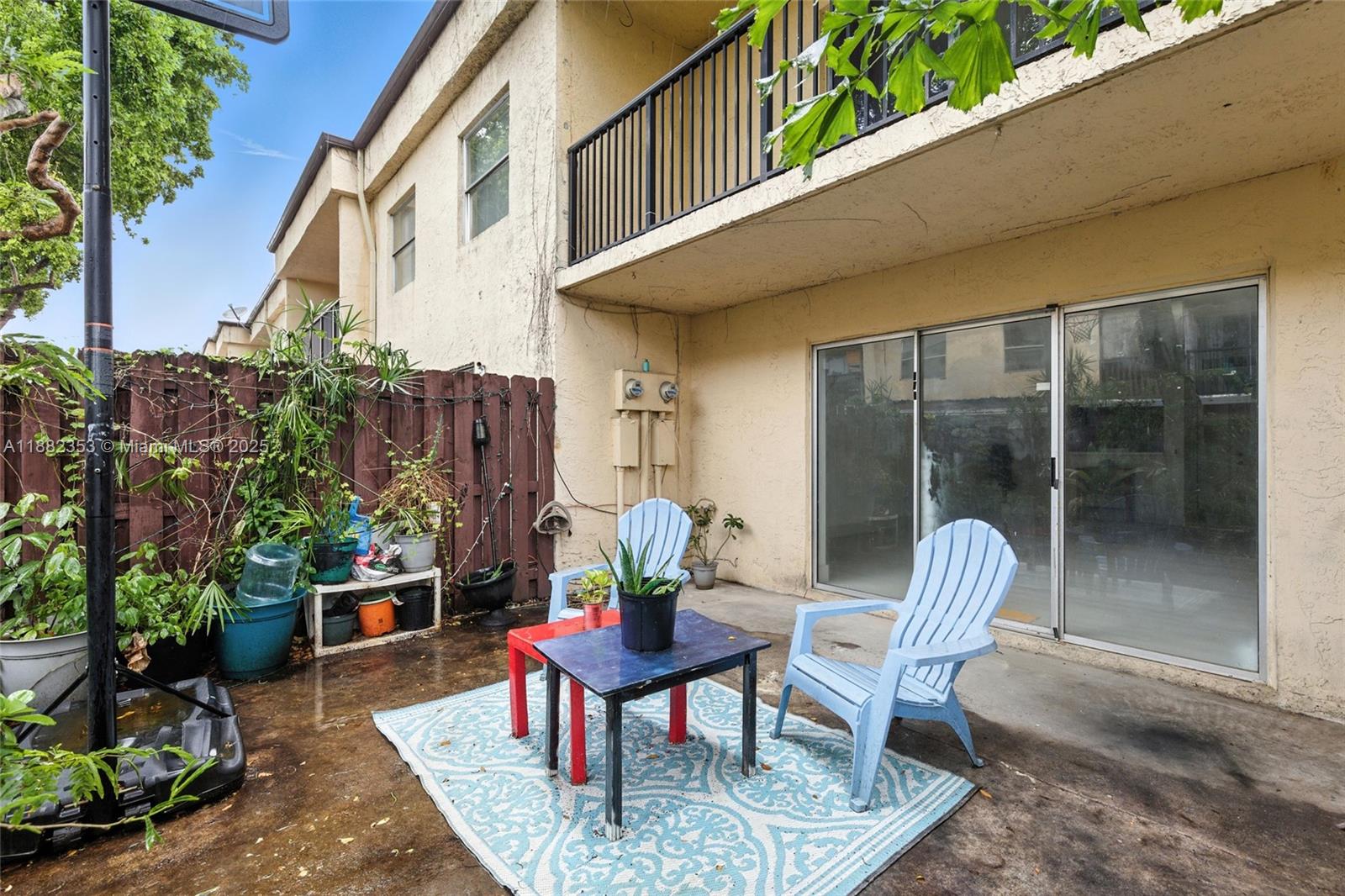 4165 Southwest 66th Terrace, Unit 109 Davie, FL 33314 - Photo 30 of 31 a view of a chairs and table in the patio