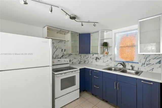 a kitchen with a sink stove and refrigerator