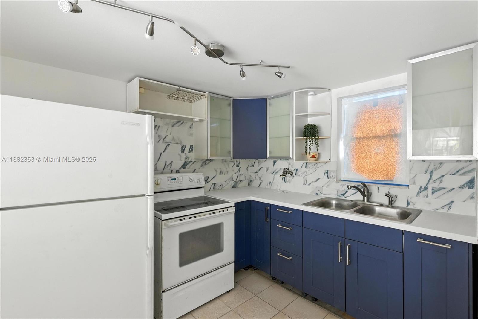 4165 Southwest 66th Terrace, Unit 109 Davie, FL 33314 - Photo 5 of 31 a kitchen with a sink stove and refrigerator