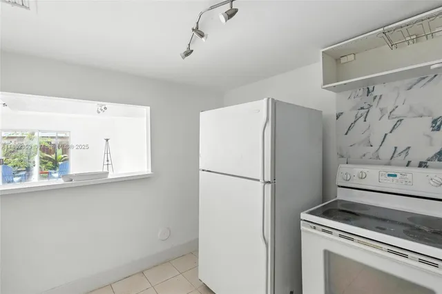 a white refrigerator freezer sitting inside of a kitchen