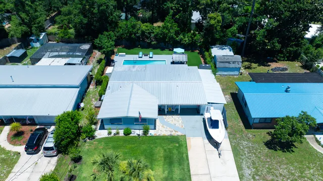 an aerial view of a house with swimming pool patio and yard