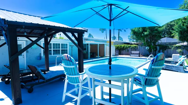 a patio with a yard table and chairs
