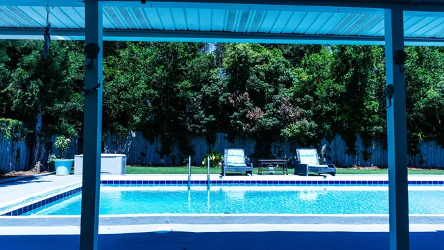 a view of patio with a table and chairs under an umbrella
