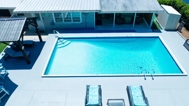 a view of swimming pool with seating space
