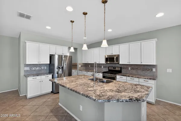 a large kitchen with kitchen island granite countertop a large counter top space appliances and living room
