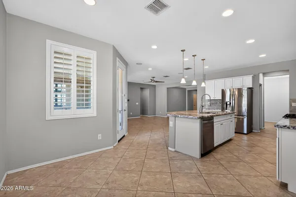 a view of a dining room with furniture and chandelier