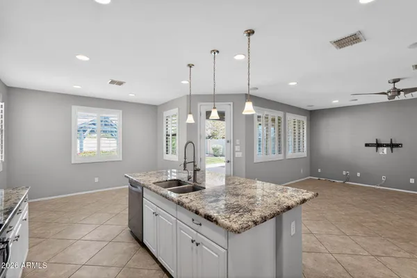 a bedroom with a bed a table and chair