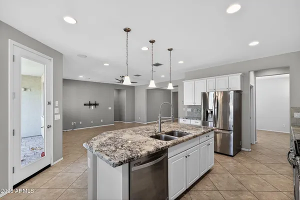 a bedroom with a bed chandelier and a window