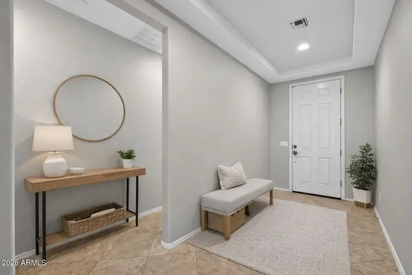 a kitchen with kitchen island granite countertop a stove a sink a microwave a refrigerator and chairs