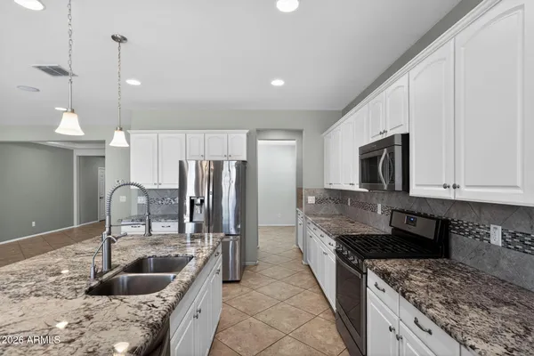 a living room with furniture kitchen view and a kitchen