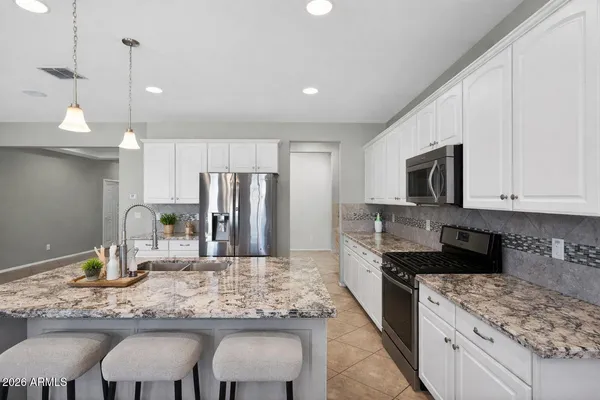 a large kitchen with a large window and stainless steel appliances