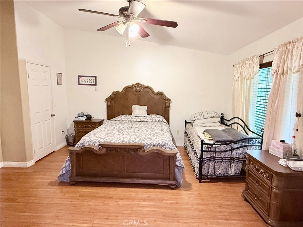 916 Roxanne Drive Hemet, CA 92543 - Photo 10 of 32 a bedroom with a bed and wooden floor
