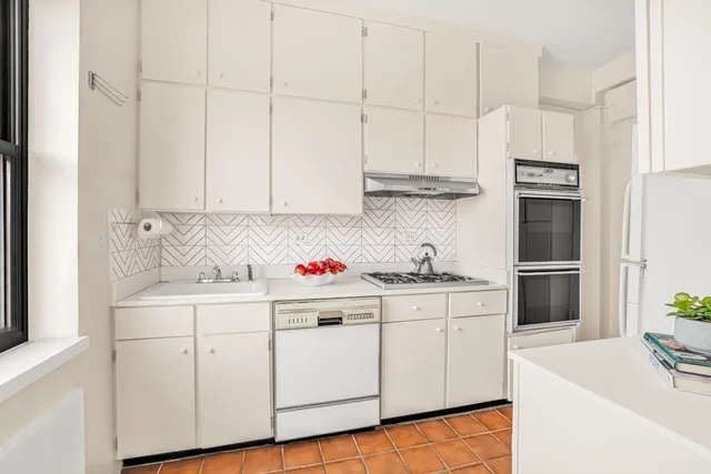 a kitchen with stainless steel appliances a sink a stove and a refrigerator