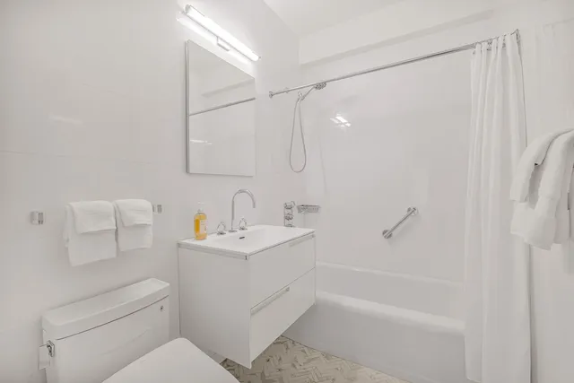 a view of an empty room and wooden floor